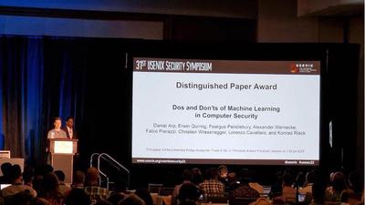The announcement of the Distinguished Paper Award at the opening of the USENIX Security 2022 conference in August 2022.